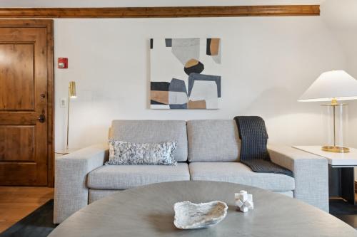 a living room with a couch and a table at The Aspen Mountain Residences in Aspen