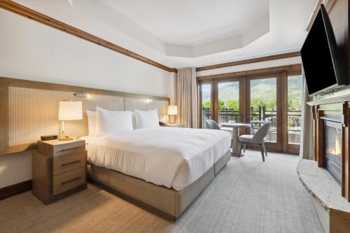 a hotel room with a bed and a fireplace at The Aspen Mountain Residences in Aspen