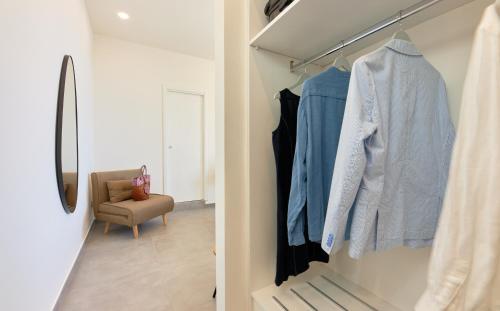 a room with a walk in closet with blue clothes at Residenza D'epoca Tamara in Castellabate