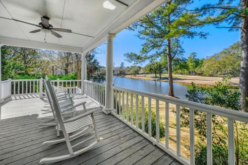 a porch with rocking chairs and a view of a river at Shearwater home by Peace Vacations in Georgetown