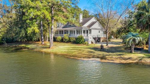 a house with a river in front of it at Shearwater home by Peace Vacations in Georgetown