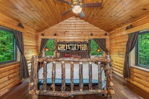 a bedroom with a bed in a log cabin at Smeagles Terrapin in Arbor Vitae WI in Boulder Junction