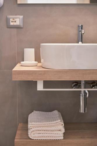 a bathroom with a sink and a counter with towels at Residenza D'epoca Tamara in Castellabate