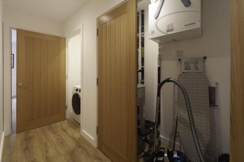 a room with a treadmill next to a door at Fantastic 2 Bedroom Apartment in Central Ashford in Ashford