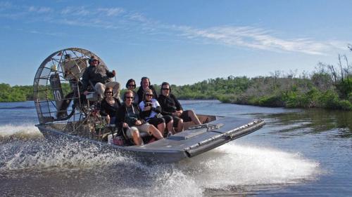 a group of people sitting on a boat in the water at Free BBQ in RV With Private entrance in Homestead