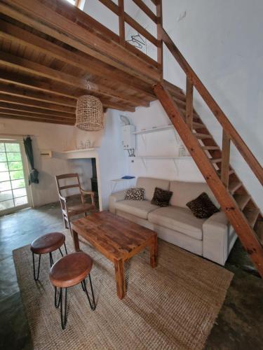a living room with a couch and a table and chairs at Casas e Glamping Quinta da Saudade in Canha