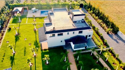 an overhead view of a large white house with a yard at Bens White House in AÃ¯n el Ksob