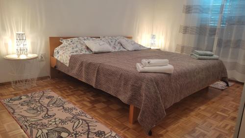 a bedroom with a bed with towels on it at Apartment Irene in Pula