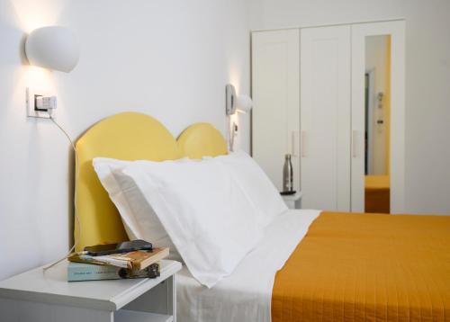 a bedroom with a bed and a table with a lamp at Hotel St. Moritz in Rimini
