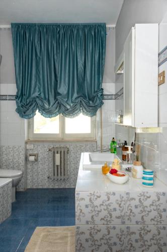 a bathroom with a sink and a window at La Casa di Paola in Graffignano
