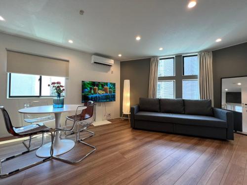 a living room with a couch and a table at Shibuya House-SY0108 in Tokyo