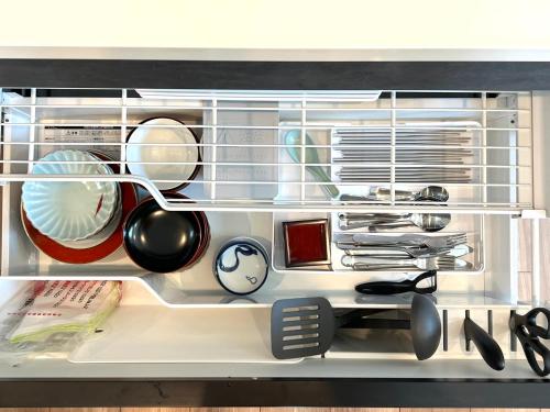 a refrigerator filled with lots of kitchen utensils at Shibuya House-SY0108 in Tokyo