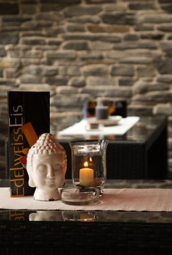 a candle and a statue of a head on a table at edelweiss lounge restaurant hotel pizza cafe billard gasthof in Mayrhofen