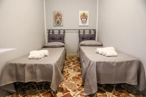 a room with two beds with towels on them at Medea Suite Panoramic in Palermo