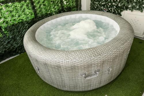 a large wicker bath tub sitting on the grass at Medea Suite Panoramic in Palermo