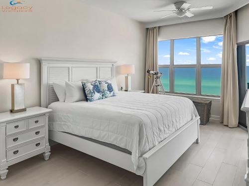 a white bedroom with a bed and a window at ETW#6004-Penthouse Beachfront Condo–Amazing Views in Fort Walton Beach