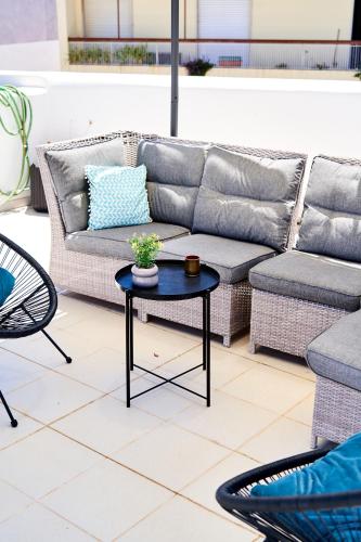 a couch and a table on a patio at Baron Faro - Guest House in Faro