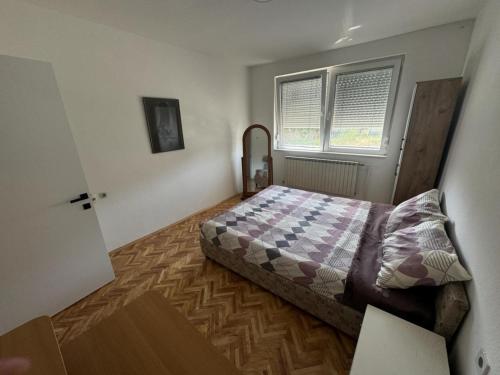a small bedroom with a bed and a window at The Great Escape in Bitola
