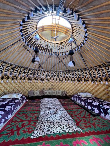 a room with a large bed in a yurt at Guest house and yurt camp Svetlana in Bokonbayevo