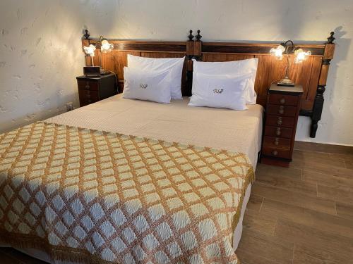 a bedroom with a large bed with two pillows at Riba Loivos Village - Studio B in Casal de Loivos