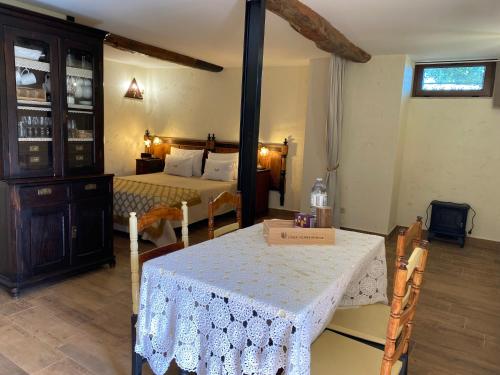 a room with a bedroom with a table and a bed at Riba Loivos Village - Studio B in Casal de Loivos
