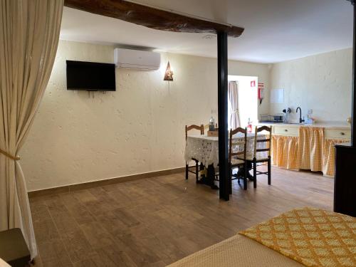 a living room with a table and a kitchen at Riba Loivos Village - Studio B in Casal de Loivos