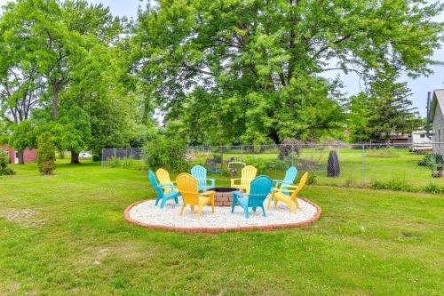 a group of colorful chairs around a table in a yard at Seneca Falls Apartment about 3 Mi to Cayuga State Park in Seneca Falls