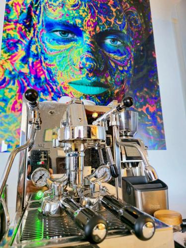 a robot in front of a painting of a woman at Horizon Retreat in Calheta