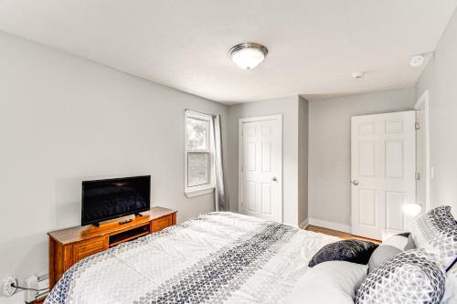 a bedroom with a bed and a flat screen tv at Seneca Falls Apartment about 3 Mi to Cayuga State Park in Seneca Falls
