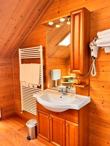 a bathroom with a sink and a mirror at Hotel & Restaurant AL TRIVIO in Altana