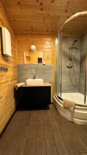 a bathroom with a tub and a sink and a shower at Andiland in Karwia