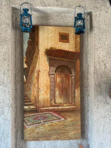 a painting of a door in a wall with lights at Heritage Home Guest House in Dubai