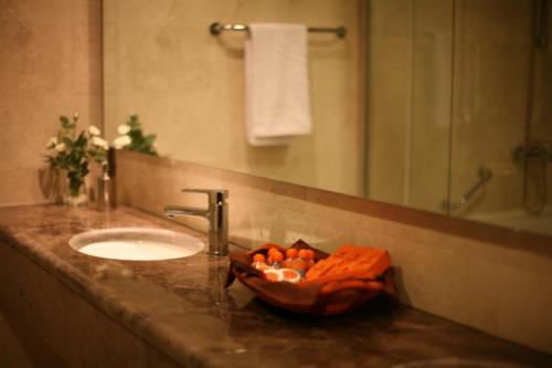 a bathroom with a sink and a bowl of oranges at Best Inn Erbil in Erbil