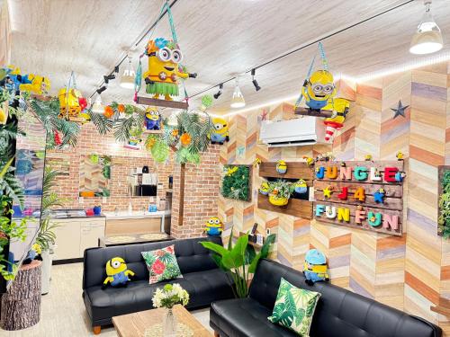 a living room with black leather furniture and a brick wall at New open Hotel Jungle fun fun J4 USJ 8minutes nishikujyo 3minutes in Osaka