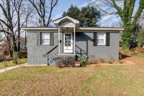 a small house with a lawn in front of it at Renovated Charlotte Bungalow - 3 Mi to Downtown! in Charlotte