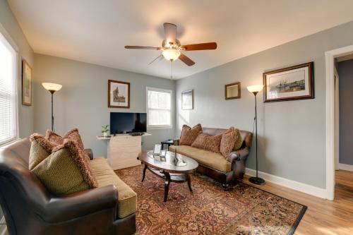 a living room with leather furniture and a ceiling fan at Renovated Charlotte Bungalow - 3 Mi to Downtown! in Charlotte