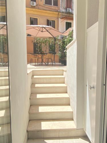 a staircase leading to a patio with an umbrella at Major House - Luxury Apartments in Rome by Hostand in Rome