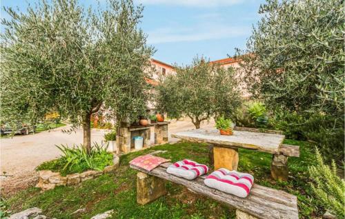 a wooden bench with slippers on it in a garden at App Damiani in Oprtalj