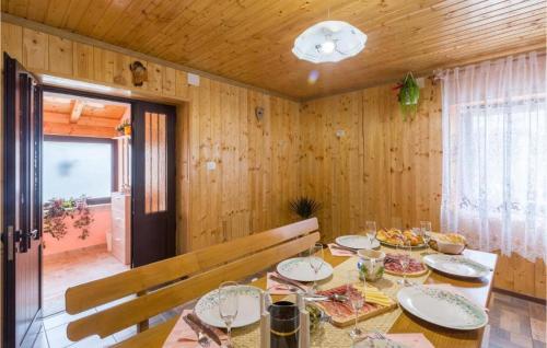 a dining room with a table with plates of food at App Damiani in Oprtalj