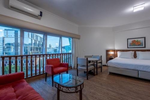 Ένα ή περισσότερα κρεβάτια σε δωμάτιο στο Plaza Blumenau Hotel