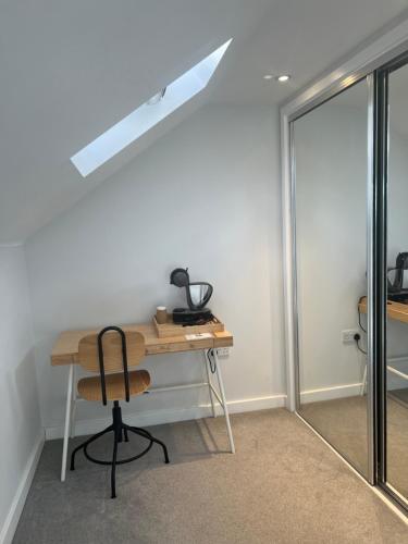 a desk and a chair in a room at Home2Us in Ashford