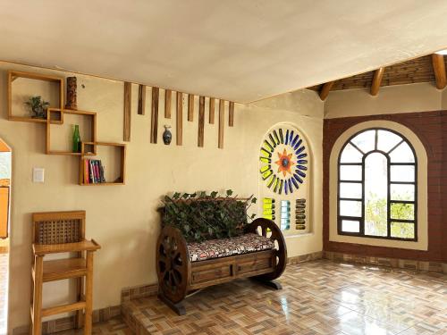a living room with a bench and a window at Cabañas Quilotoa in Quilotoa