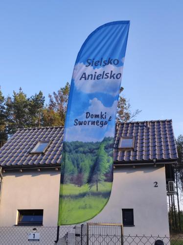 a flag in front of a building at Sielsko Anielsko -Domki Swornegacie in Swornegacie 