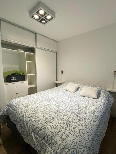 a bedroom with a bed with two pillows on it at Dpto Frente al mar Av Bunge y Av Del Mar in Pinamar