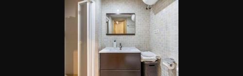 a bathroom with a sink and a mirror at Rural-ya Alojamientos Granada Nevada home in La Zubia