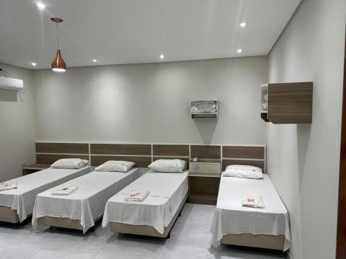 a hospital room with three beds in it at Estação Sé Hotel in Sao Paulo
