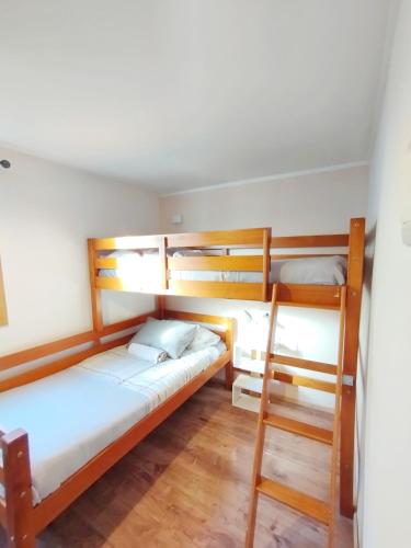 a room with two bunk beds and a ladder at Casa Giovanna in Puerto Natales