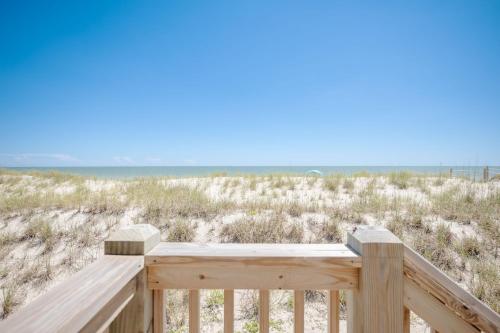 a deck with a view of the beach at Lowe Tide by Oak Island Accommodations in Oak Island