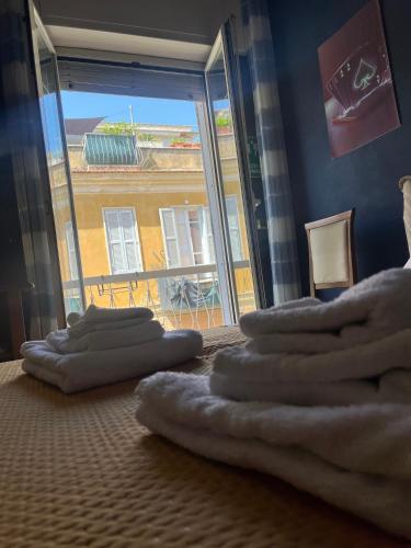 a room with a pile of towels on the floor at Specter Guesthouse in Nettuno