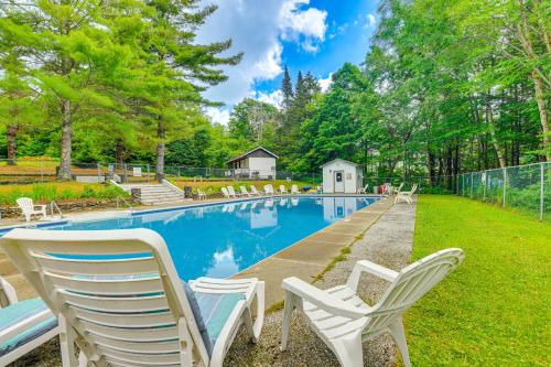 a swimming pool with white chairs in a yard at Pet-Friendly Home with Deck 4 Mi to Jay Peak Resort in Montgomery Center